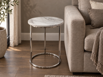 SS base with stone top end table beside a sofa in a contemporary living room