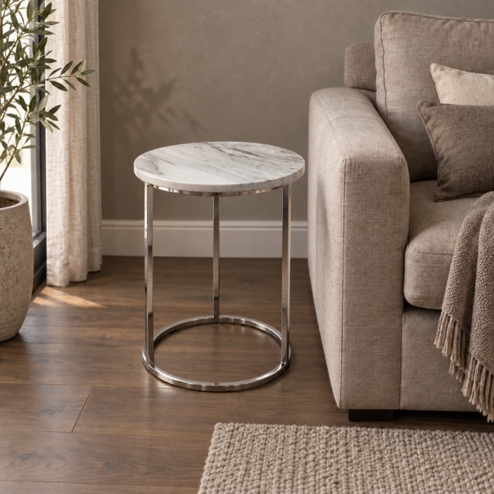 SS base with stone top end table beside a sofa in a contemporary living room