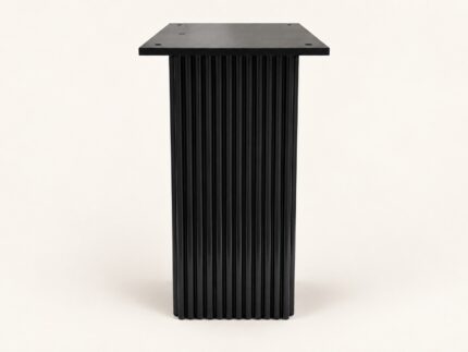 Black wooden carved base end table on warm ivory background