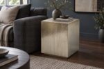 Hammered metal cladded end table beside a charcoal sofa in a contemporary living room