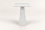 White stone end table on warm ivory background
