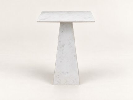 White stone end table on warm ivory background