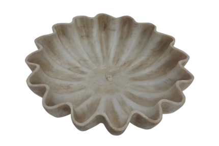 Decorative beige fluted ceramic bowl on display