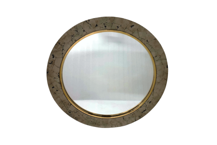 Round vintage mirror with decorative gold trim.