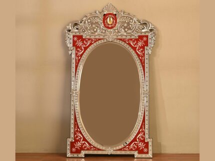 Ornate vintage mirror with red decorative frame