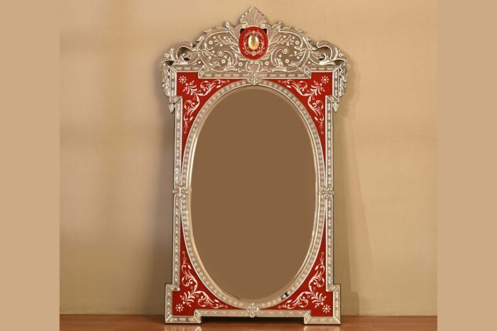 Ornate vintage mirror with red decorative frame