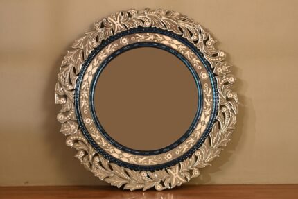 Ornate round mirror with decorative floral frame