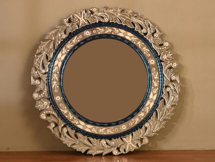 Ornate round mirror with decorative floral frame