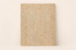Rectangular bone inlay on plywood panel with dense ivory and warm beige linear texture
