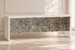 Long white MOP inlay cabinet with starburst-patterned front in a bright neutral interior