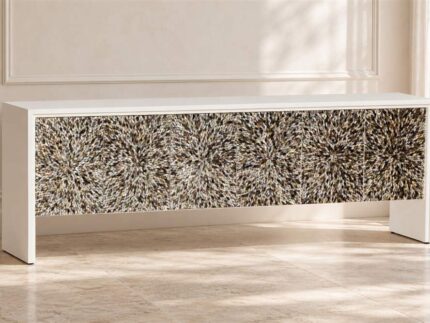 Long white MOP inlay cabinet with starburst-patterned front in a bright neutral interior