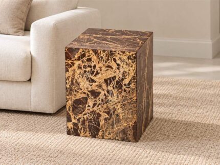 Red Cherry Cube Table with rich red-brown and gold veining beside a cream sofa in a living room