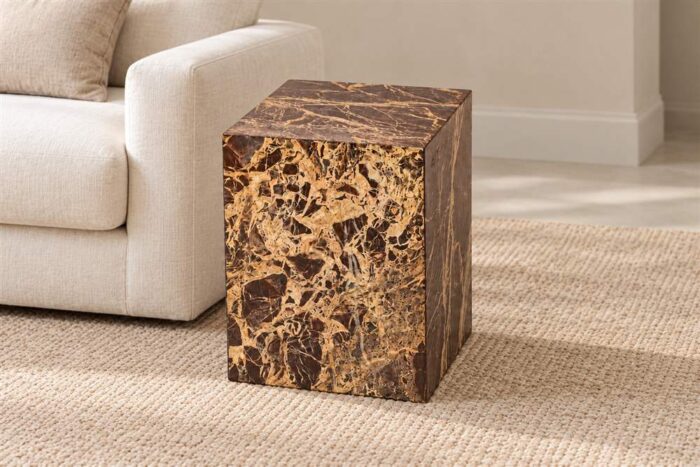 Red Cherry Cube Table with rich red-brown and gold veining beside a cream sofa in a living room