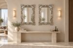 Pair of Signature Living silver mirror frames above a travertine console