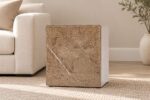 Brown stone end table beside a cream sofa in a warm neutral living room