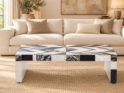 Black-and-white stone inlay coffee table in front of a cream sofa in a warm living room