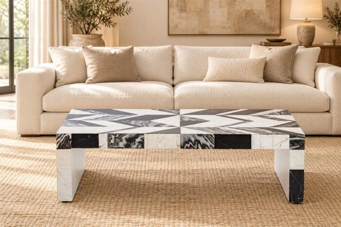 Black-and-white stone inlay coffee table in front of a cream sofa in a warm living room